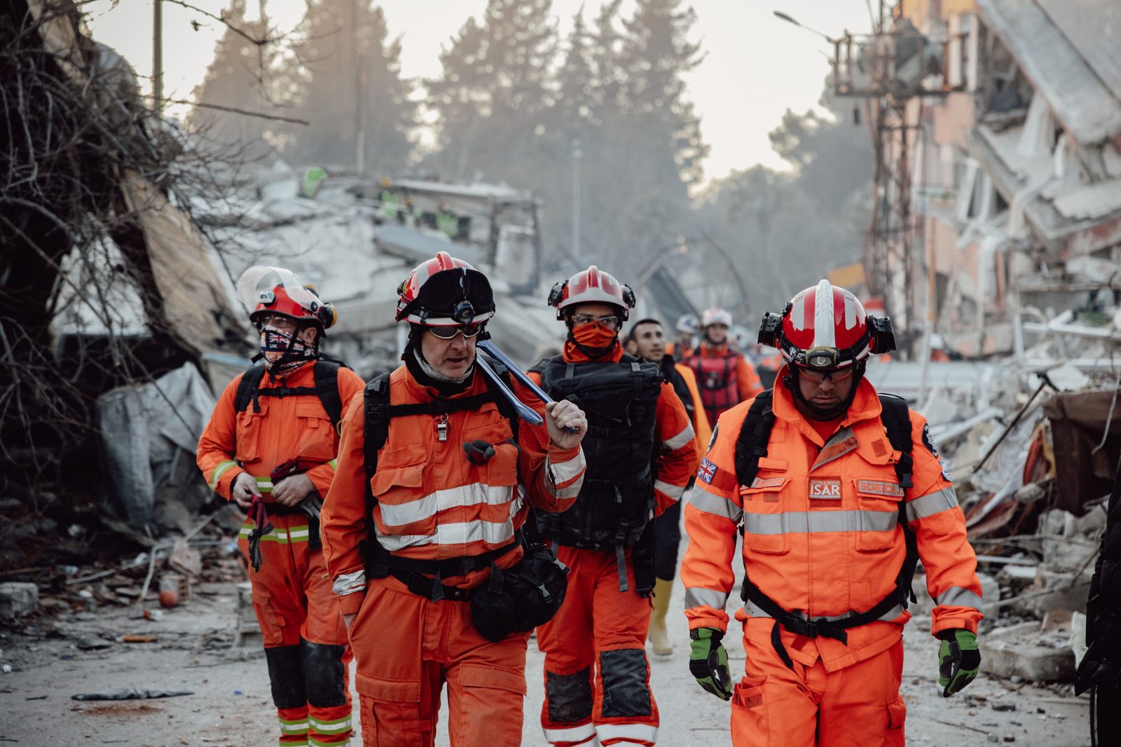 Emergency response workers walking through a disaster site